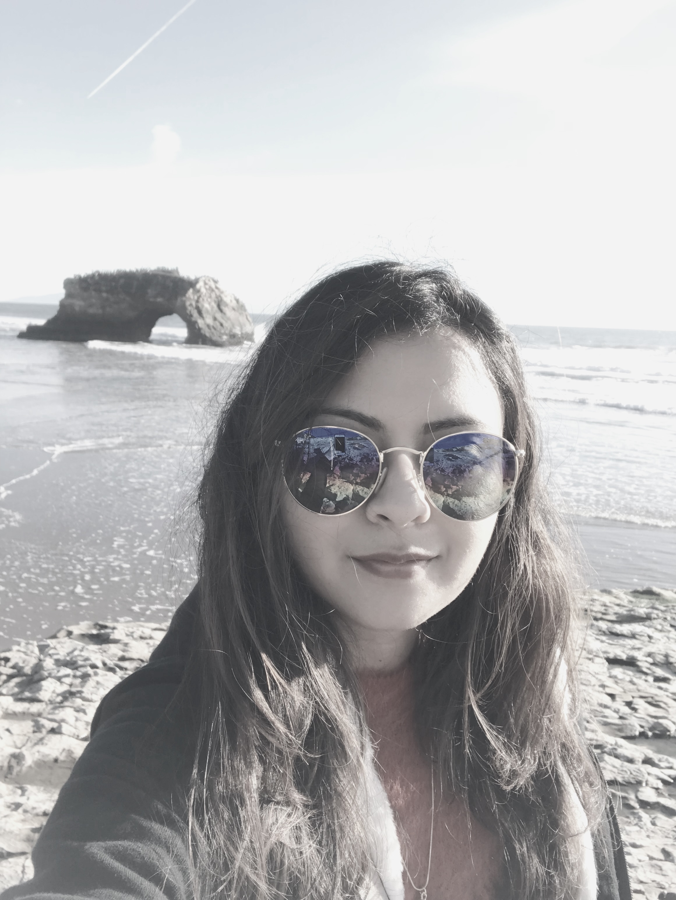 A robot presents a user journey diagram on a poster to two people at a conference table.